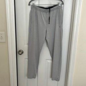 Light weight grey sweat pants with drawstring waist and one zipper pocket